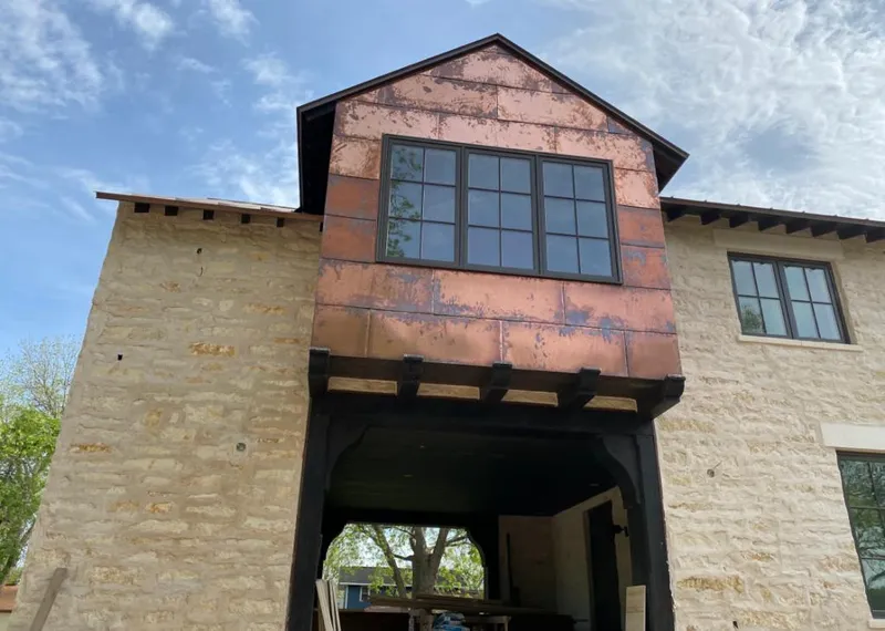 Copper metal panel facade on a stone building for Roof Repair in Hinesville